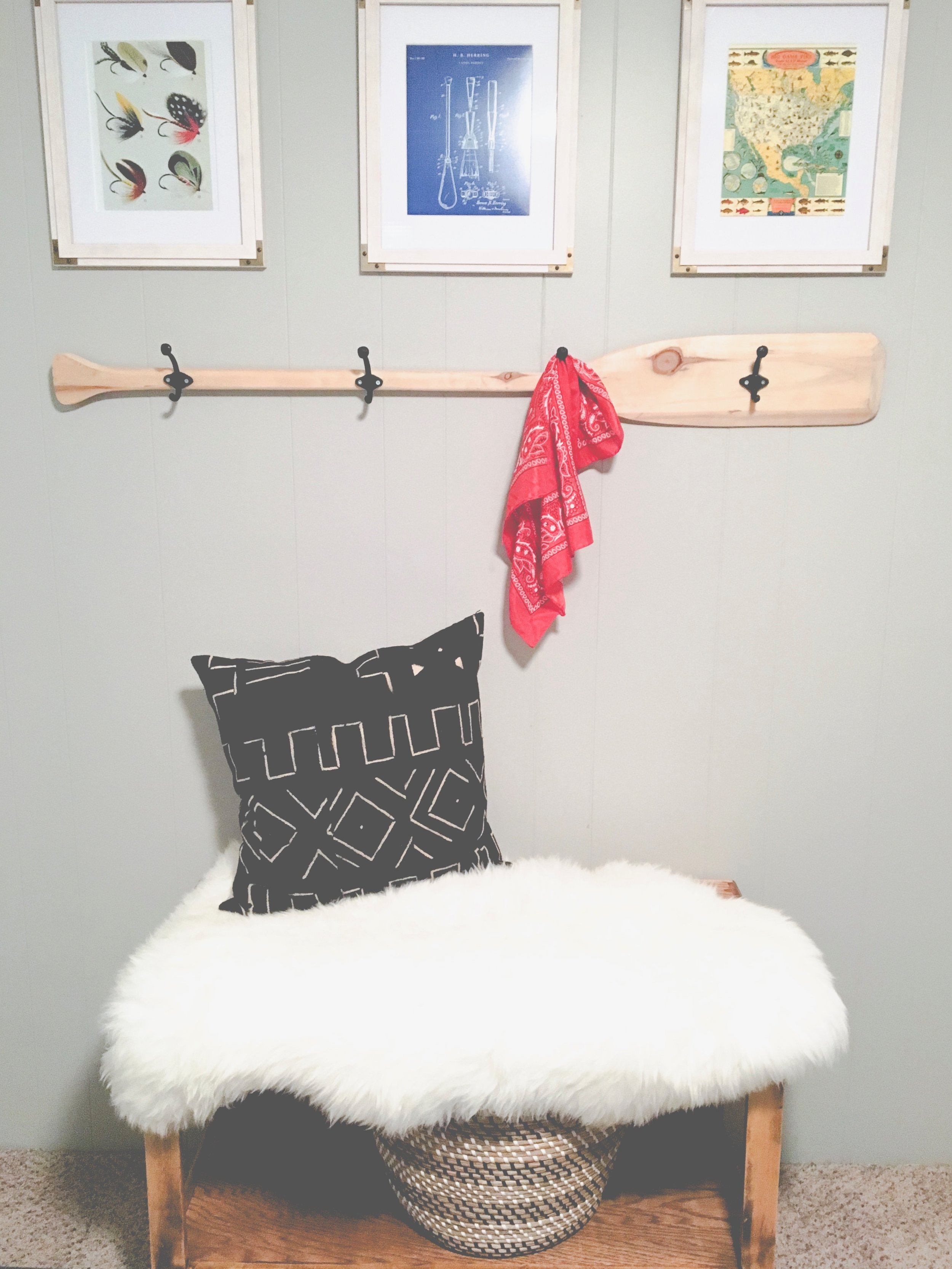 Our boring guest room gets a whole new modern cozy chic cabin look! Learn how to redecorate your guest room so it feels cozy and welcoming. This wooden oar hook and vintage fishing prints are a great touch.